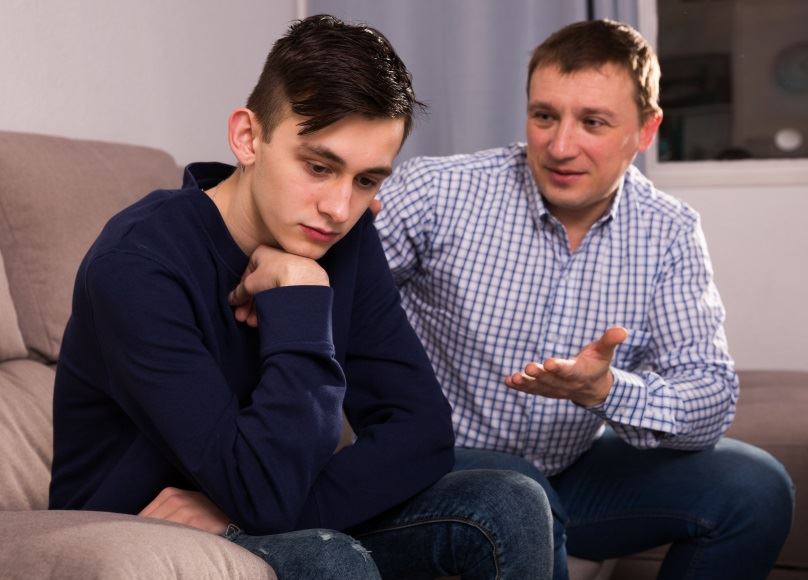 Father speaking with distraught son